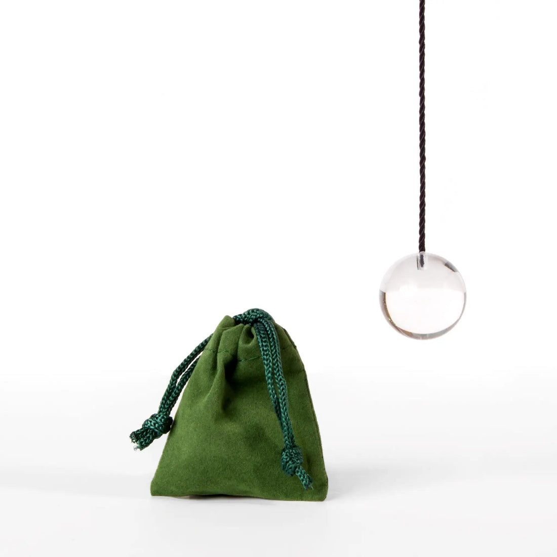 photo of a pendulum and protective green bag