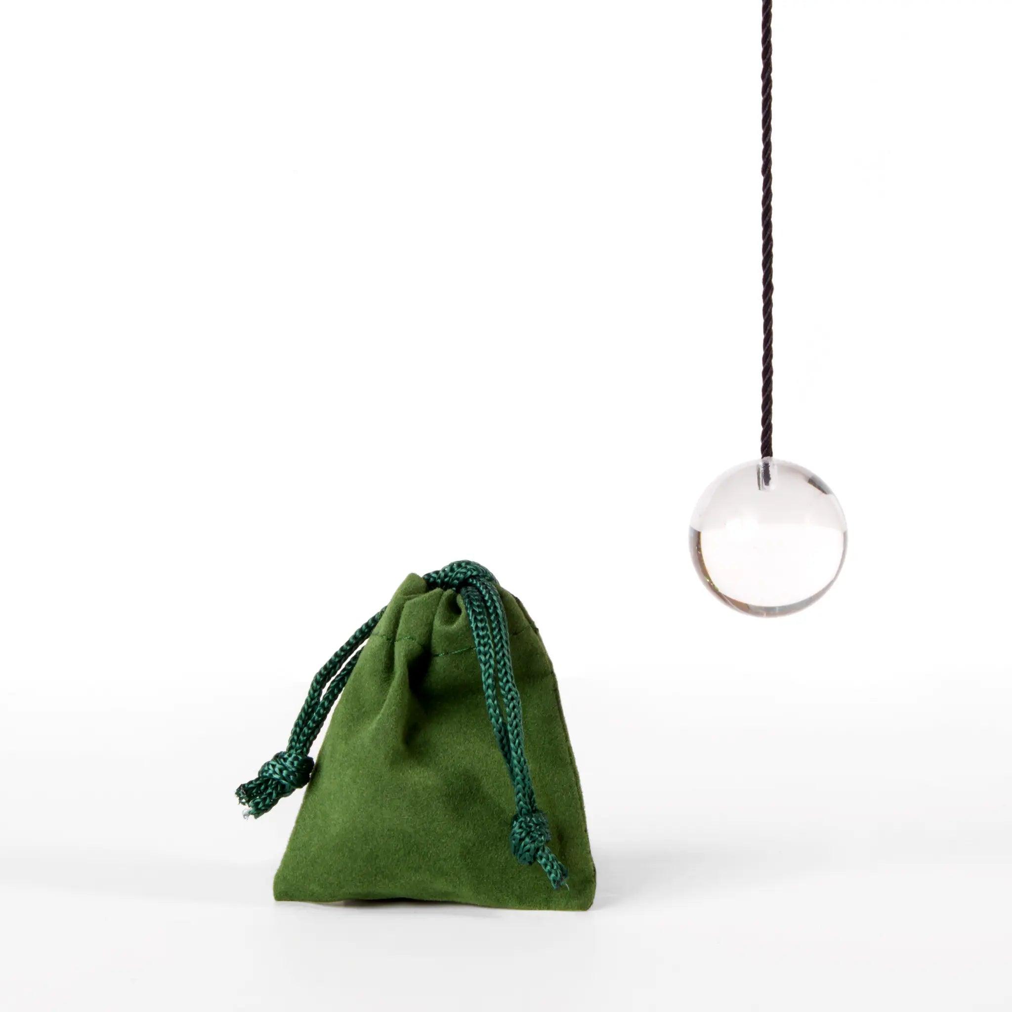photo of a pendulum and protective green bag