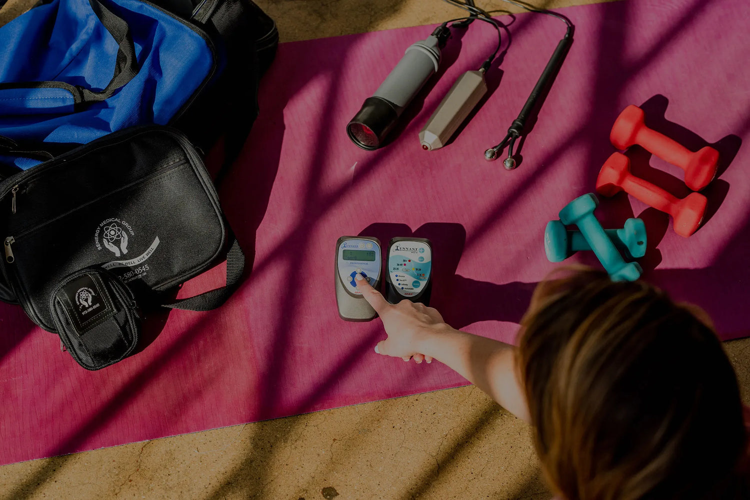photo of a workout mat that has hand weights, both the biomodulator pro and plus, large and small carrying case, biotransducer pro and crystal wave