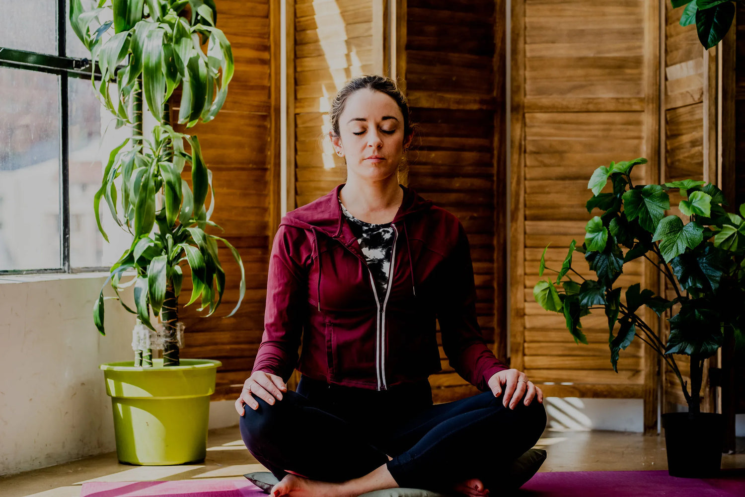 photo of a woman sitting cross legged and meditating