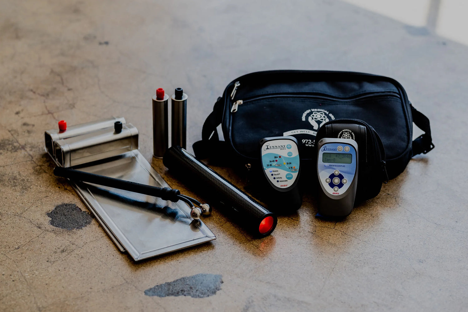 Photo of a the biomodulator pro, with the biomodulator plue, biotransducer pro, foots plates, hand grips and y-electrode with carrying case.